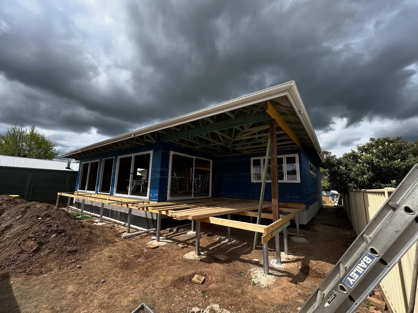 Rochester custom home in construction, showing exposed eave framing
